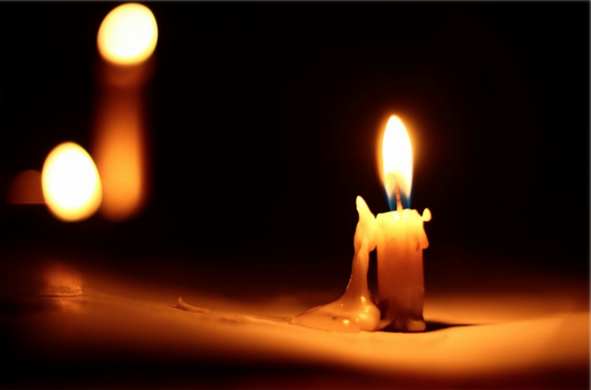 Candles lit in a dark space